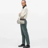 Bolso bandolera con tachuelas y gafas de sol