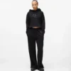 Pantalones de chándal con monograma y tachuelas
