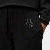 Pantalones de chándal con monograma y tachuelas